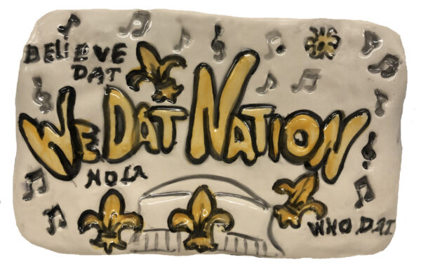 WE Dat Nation Ceramic Plaque with Fleur De Lis and music notes.