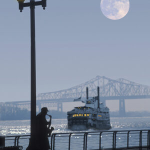 Jazz Player playing blue riverside in front of a steam boat.