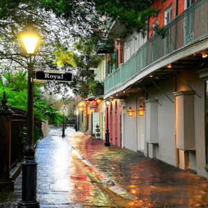 French Quarter in New Orleans with wet reflective sidewalks.