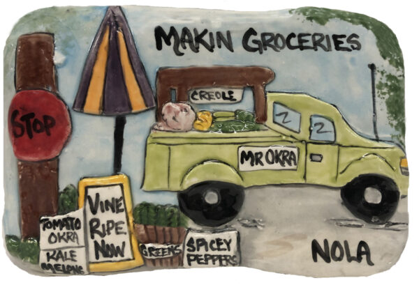 Ceramic plaque of Mr. Okra's famous Makin' Groceries truck parked in the city.