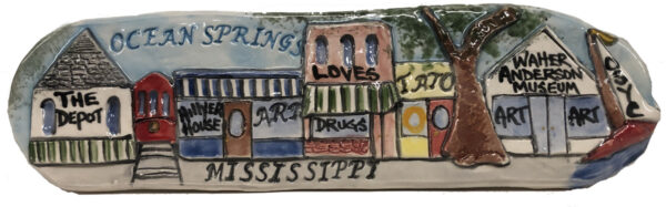 Ceramic plaque depicting stores & galleries along the street in Ocean Springs, MS.