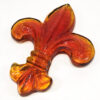 Sun Burst Orange glass Fleur De Lis Paperweight.