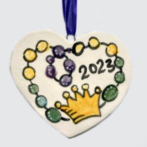 Heart Shaped Ceramic Ornament with Beads and 2023 painted on it.