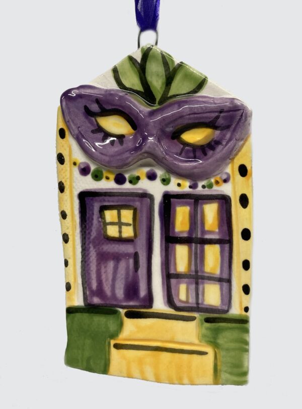 Ceramic ornament as house decorated with a mask for Mardi Gras.