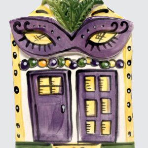 Ceramic plaque as a house decorated for Mardi Gras with large purple mask.
