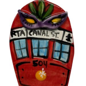 Red streetcar decorated with a Mardi Gras mask ceramic ornament hand painted by Katie Baldwin
